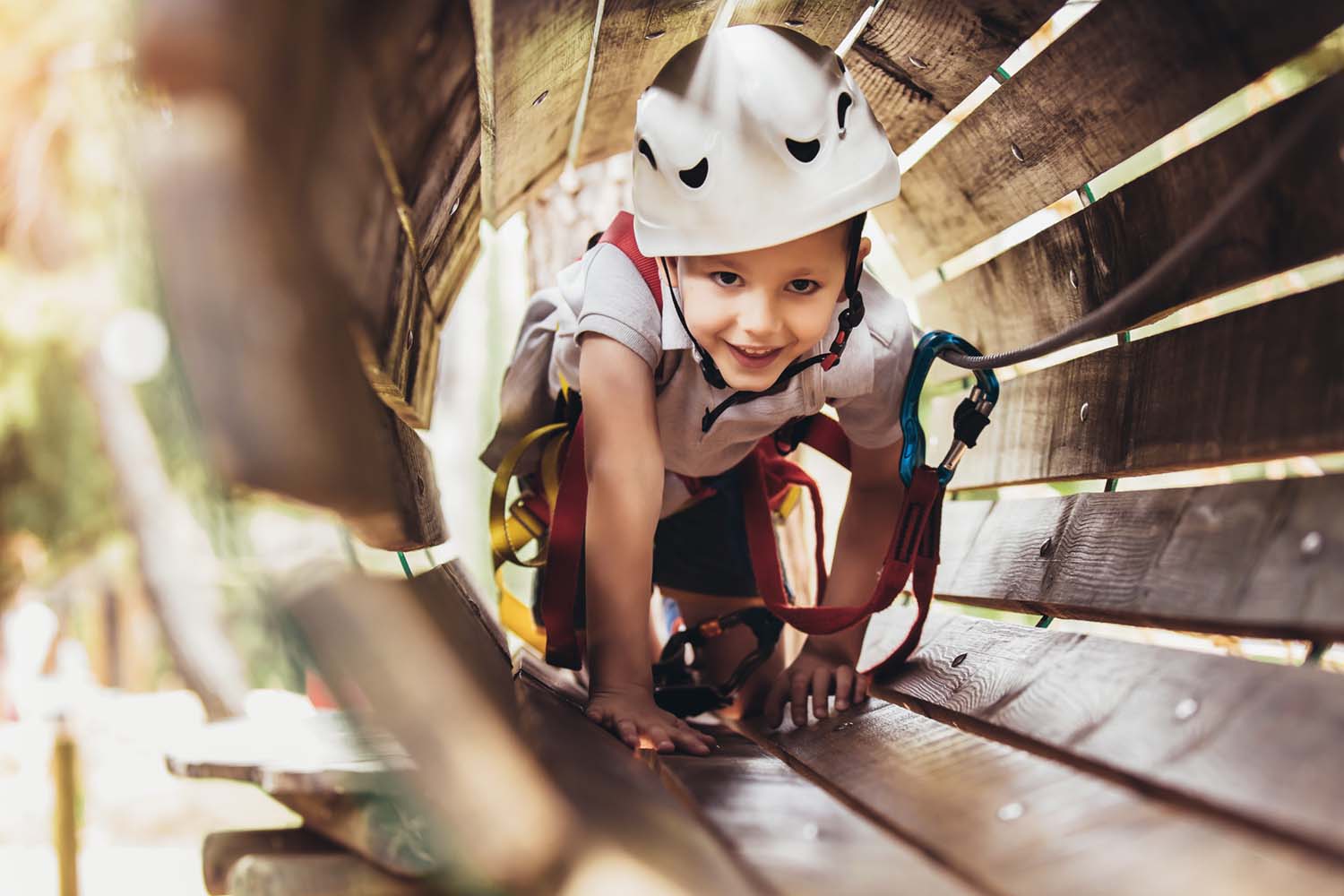 Kindergeburtstag in Urban's Kletterpark Kind klettert durch Röhre in Kletterpark